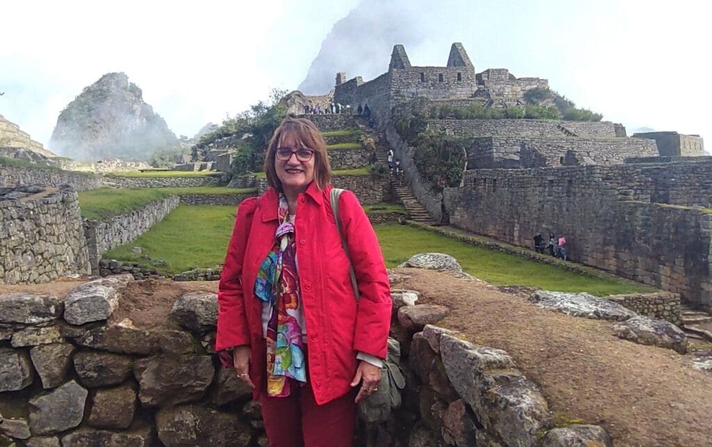 Anne C. Schneider standing at Machu Picchu, Peru, during a Solar Return journey.
