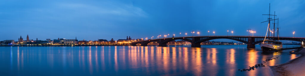 Theodor-Heuss-Brücke spanning the Rhine River in Mainz at dusk, connecting Mainz and Wiesbaden.