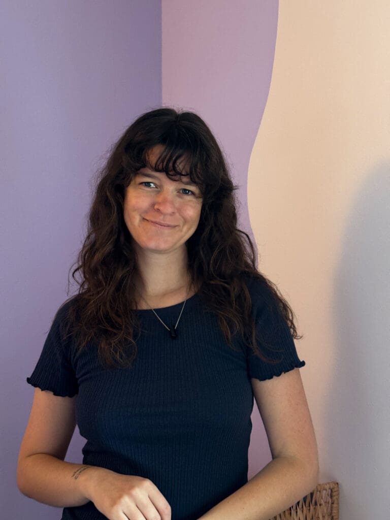 Portrait of astrocartographer Nynne Noël standing indoors in her workspace, featured in the About section of the European Astrocartography Interview Series.