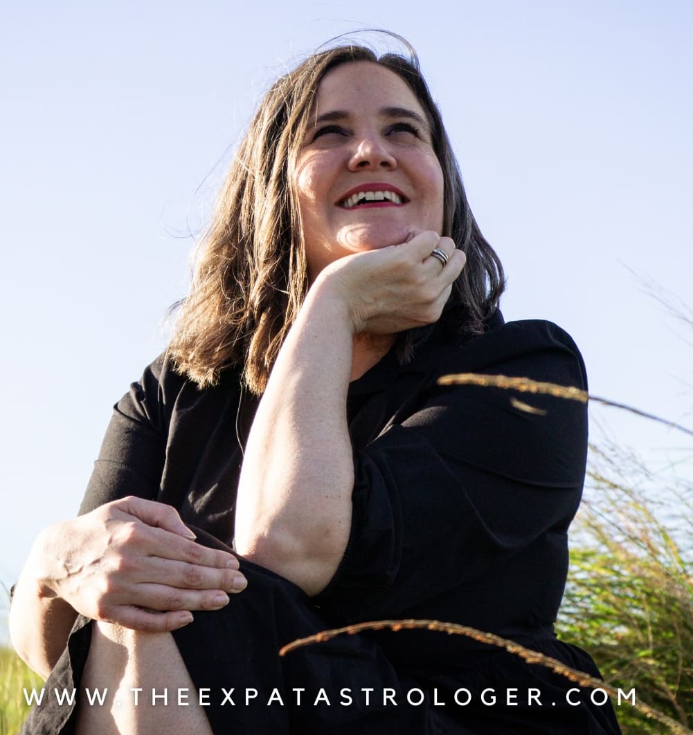 Meg Knox-Davies astrocartographer portrait in natural outdoor setting looking upward, representing reflective practice in astrocartography within the European Astrocartography® Interview Series